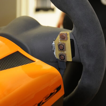 Buttons mounted at the back of the steering wheel